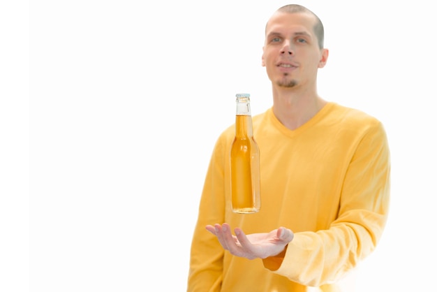 A glass bottle of beer levitates above the men's hands isolated on a white background Alcohol Beer Adult Drink Bar Lager Person Face Man Portrait Caucasian Middle Age Young Glass Yello