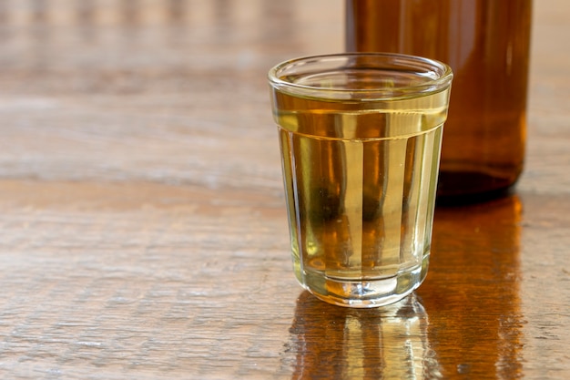 Glass and bottle of cachaça, a typical Brazilian drink.