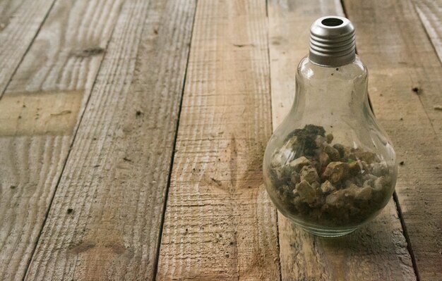 Glass bottle placed on wooden floor.