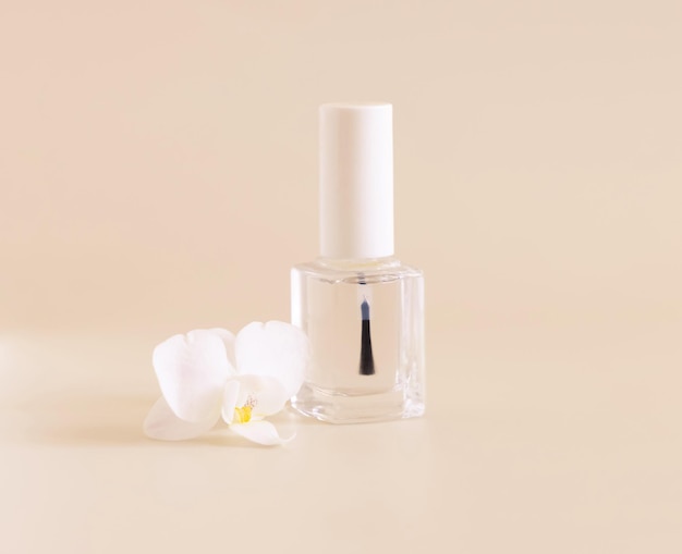 Glass Bottle with Brush Cap near white orchid flower on light yellow Mockup