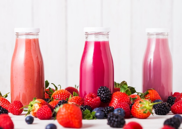 Glass bottle with fresh summer berries smoothie