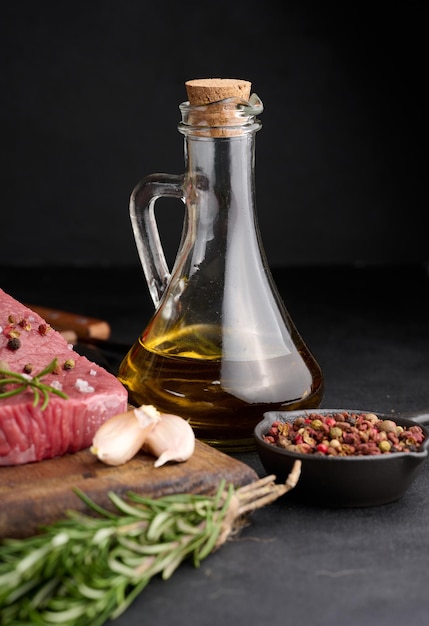 Glass bottle with olive oil on black table