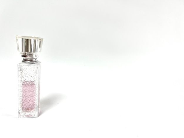 Glass bottle with perfume on a light background