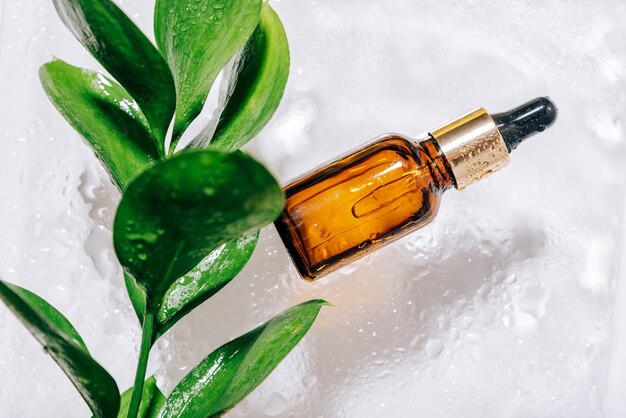 Glass bottle with pipette with drops on it