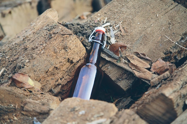 Glass bottle on wooden stack