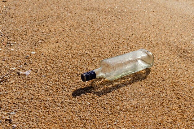 Glass bottles are left on the beach as waste polluting nature Plastic is hard to degrade destroy the ecosystem World environment day concept