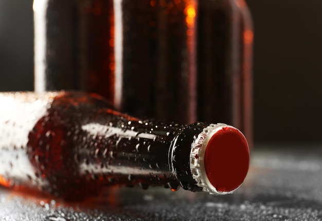 Glass bottles of beer on dark background