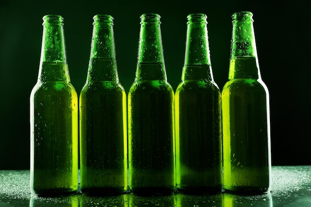 Glass bottles of beer on dark background