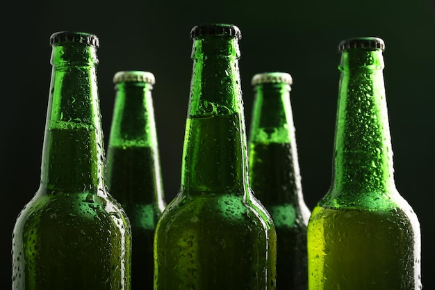 Glass bottles of beer on dark background