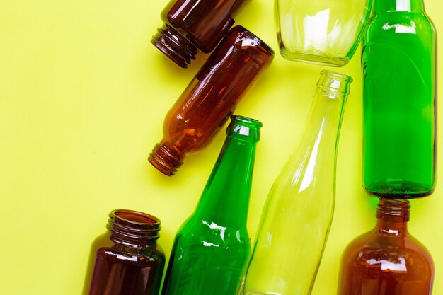 Glass bottles on green yellow background. 