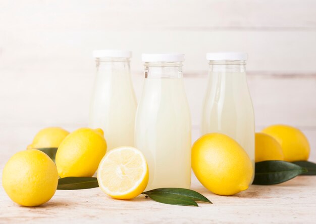 Glass bottles of organic fresh lemon juice fruits