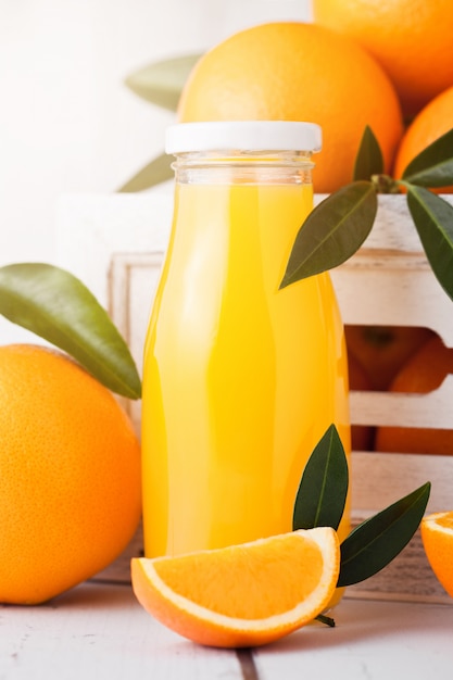 Glass bottles of raw organic fresh orange juice