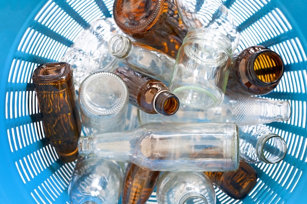 Glass bottles in waste basket. 