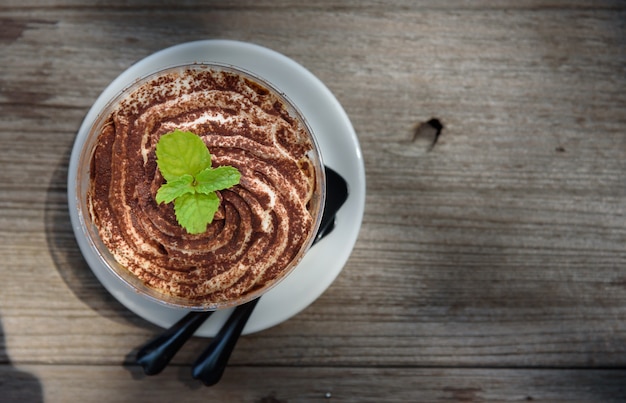 The glass bowl of Banoffee with whipped cream 