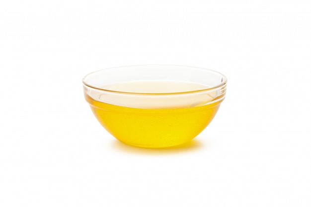 Glass bowl of honey isolated