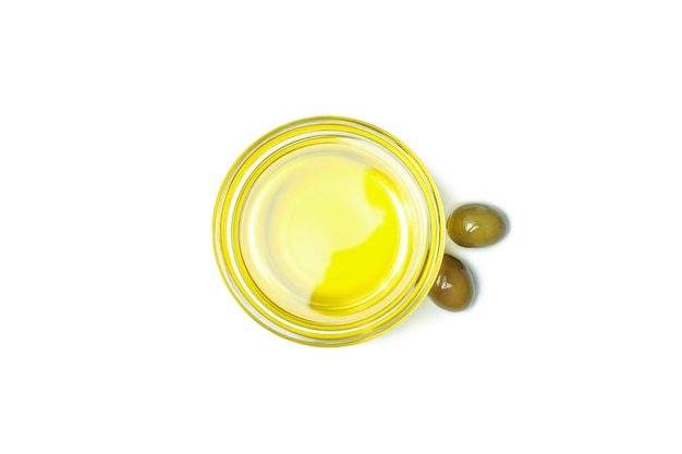 Glass bowl of olive oil isolated on white background