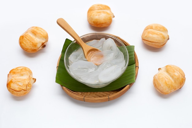 Glass bowl of sliced toddy palm in syrup on white background.