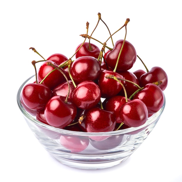 Glass bowl of sweet cherry fruits isolated on white