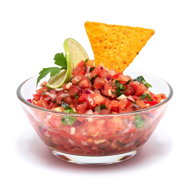 Glass bowl of tomato salsa dip with Tortilla chips isolated on white background