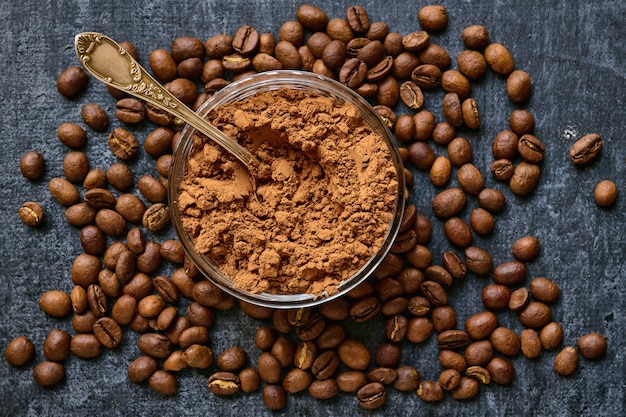 Glass bowl with cocoa powder and placer coffee beans around