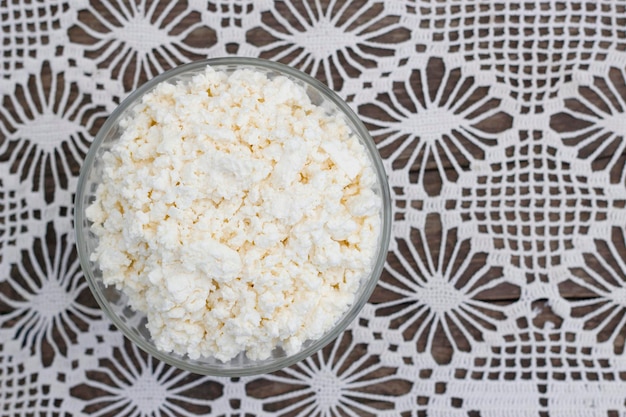 glass bowl with fresh farm curd on the table with handmade vintage tablecloth