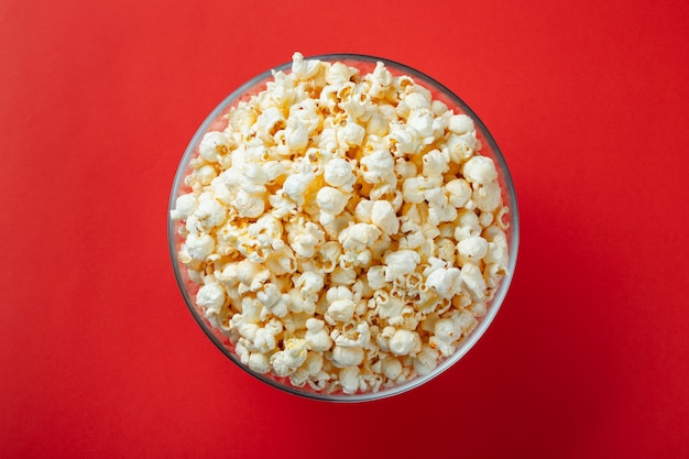 Glass bowl with salted popcorn.