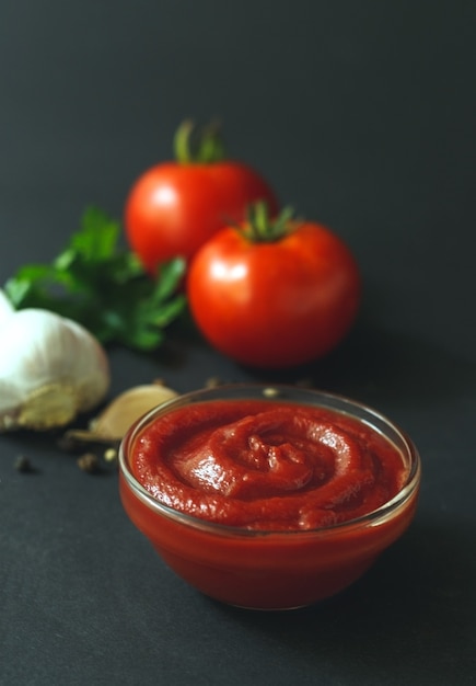 Glass bowl with tasty barbecue sauce onblack