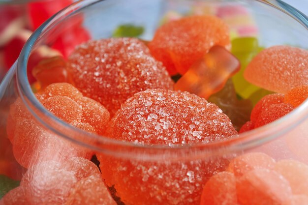 Glass bowl with tasty candies closeup