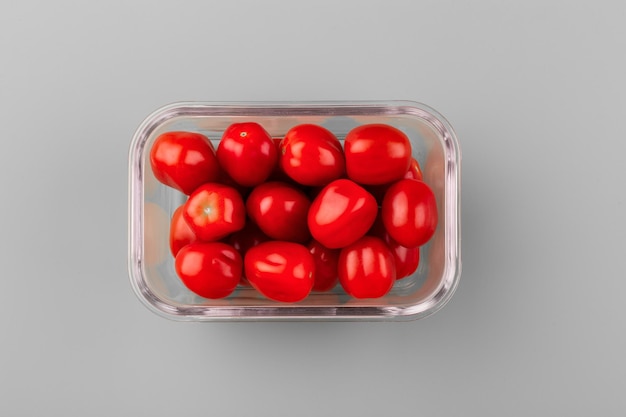 Glass box with fresh cherry tomatoes Vegetables in a glass containers Food storage concept