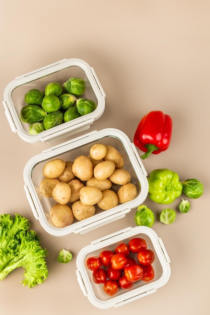 Glass boxes with fresh raw vegetables Vegetables and fruits in glass containers Food storage concept