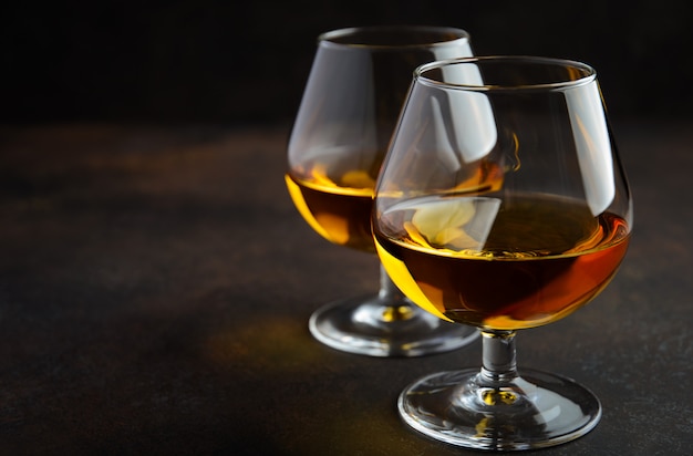 Glass of brandy or cognac on rusty wood