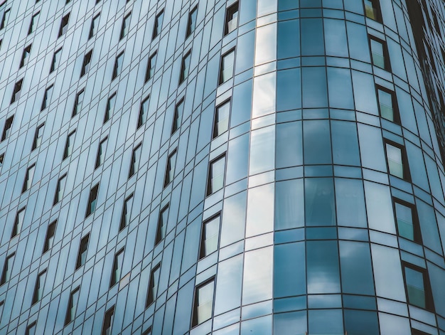 A glass building with a blue facade and the word " the word " on the side. "