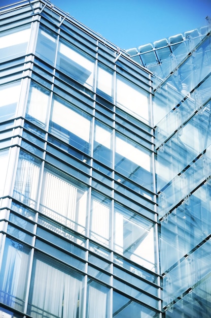 A glass building with a blue sky background