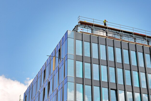 Glass building with transparent facade of the building and blue sky Structural glass wall