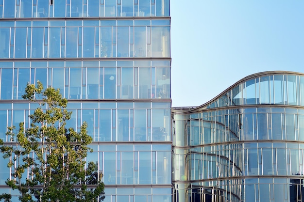 Glass building with transparent facade of the building and blue sky structural glass wall