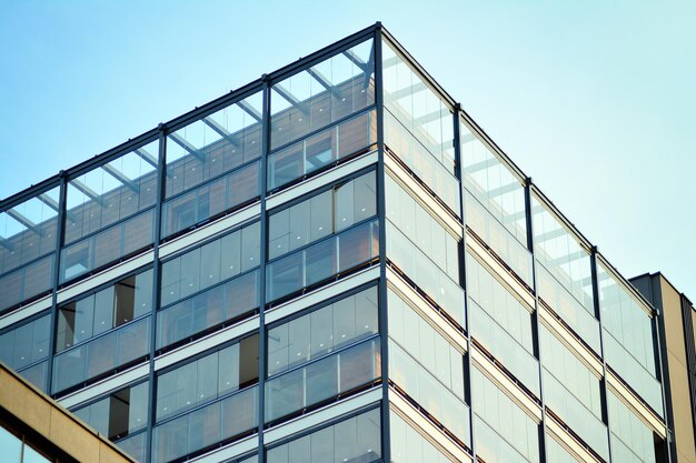 Glass building with transparent facade of the building and blue sky structural glass wall