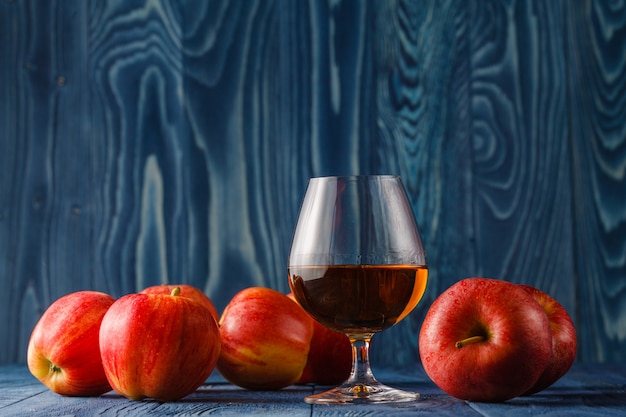 Glass of Calvados Brandy and red apples