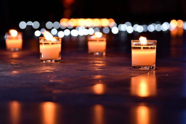 Glass candle and its reflection on floor with bubble blur background