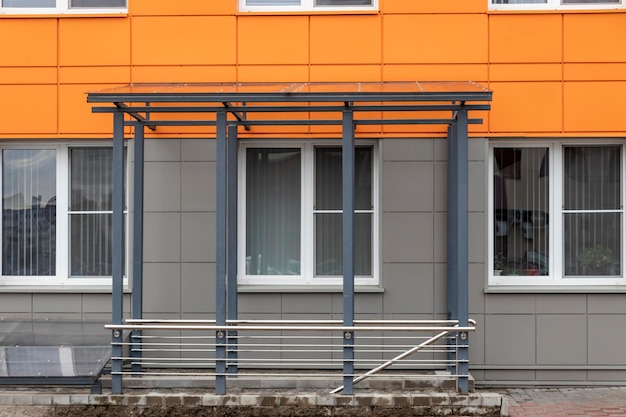 Glass canopy to protect from precipitation at the entrance to a modern office building