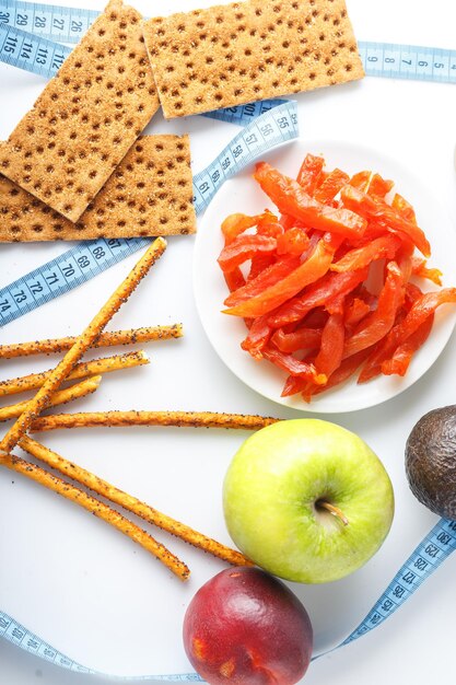 glass of celery juice crackers and fruits meat snacks on a plate dried pieces of Carpaccio meat