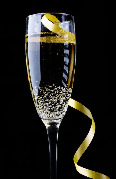 Glass of champagne on black background