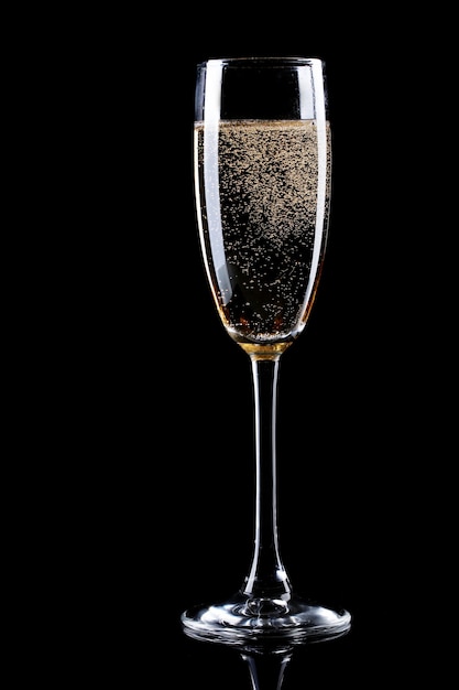 Glass of champagne on black wall