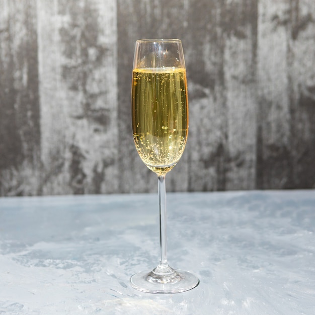 Glass of champagne isolated on a gray