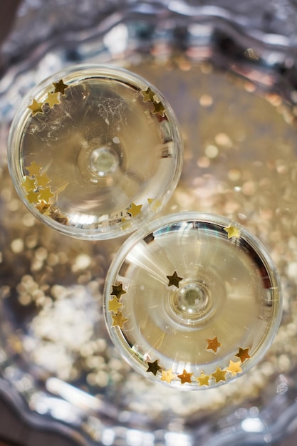 Glass of champagne with golden stars