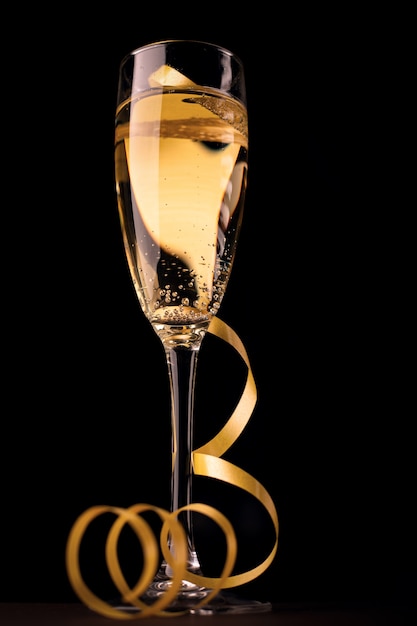 Glass of champagne and yellow ribbon