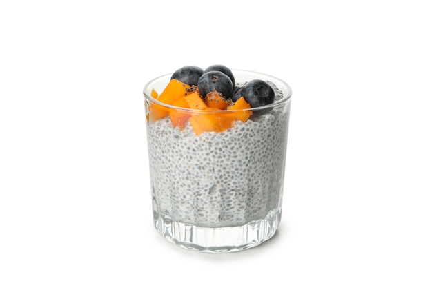 Glass of chia pudding with fruits isolated on white background