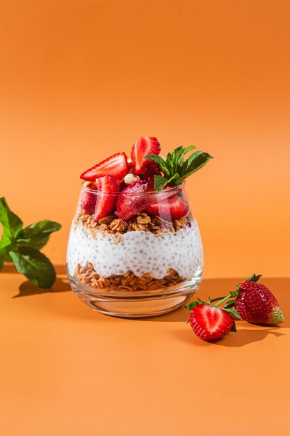 A glass of chia pudding with strawberries on top.