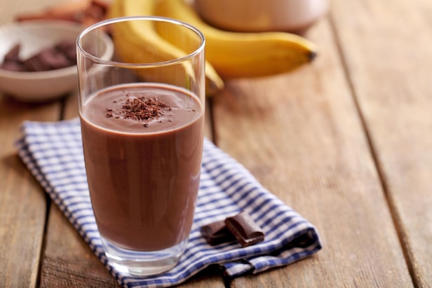 Glass of chocolate milk on table closeup