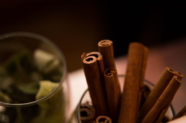 glass of cinnamon sticks and leaves