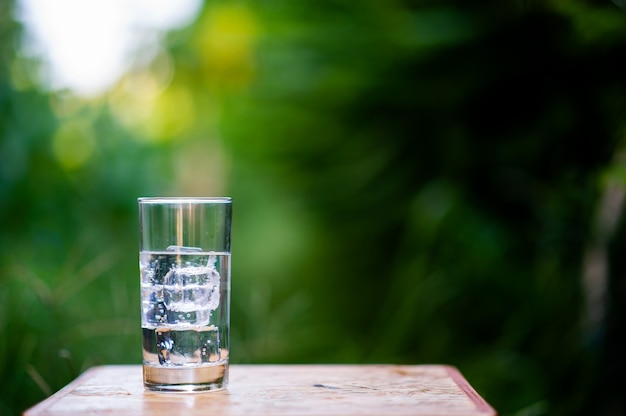 A glass of clean water with ice placed on the table ready to drink
